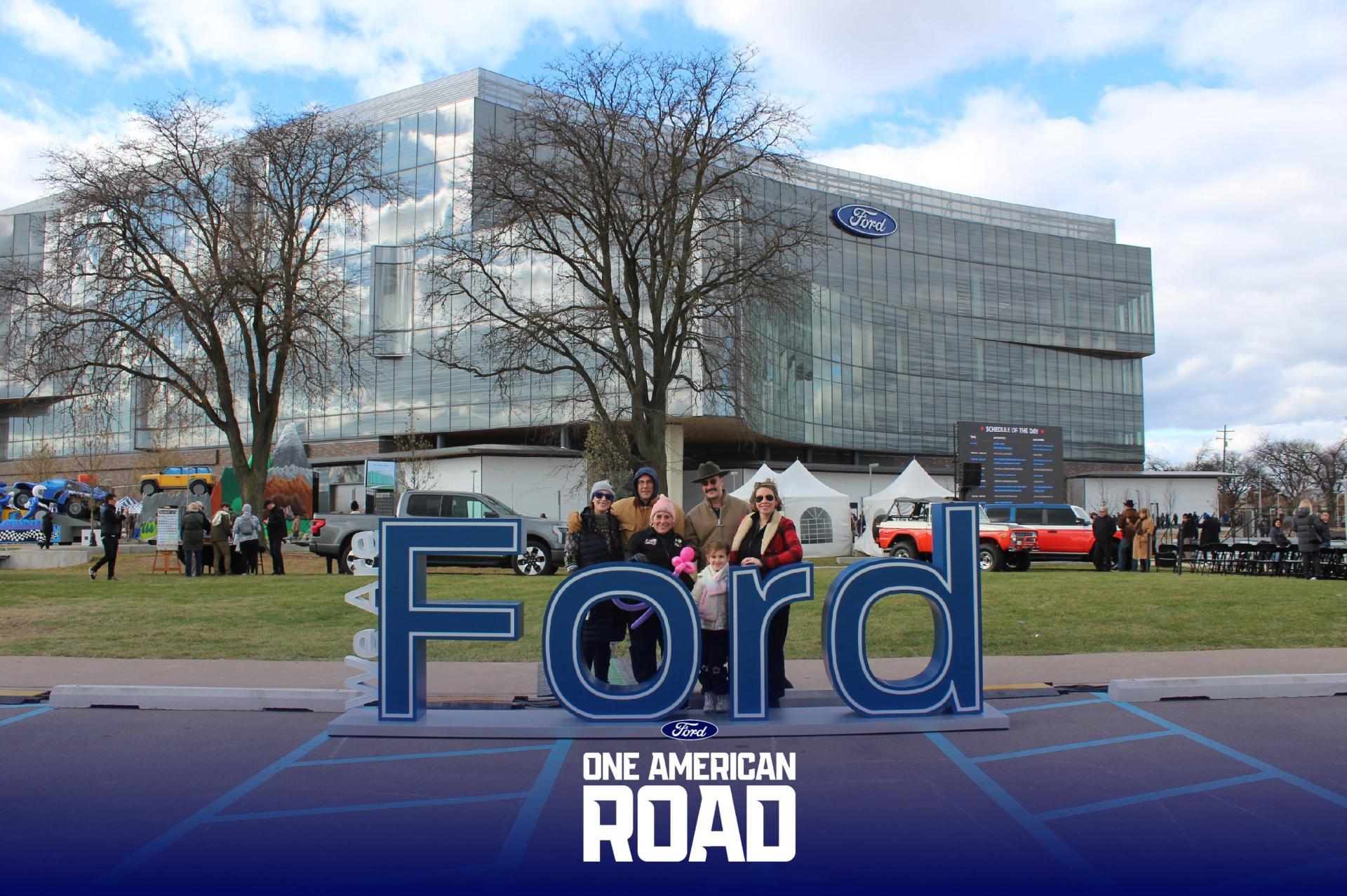 Gabrielle Poshadlo and family pose in front of the new Ford World Headquarters on Nov. 16, 2025.
